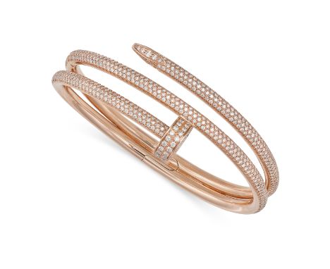 A DIAMOND NAIL BANGLE in 18ct rose gold, designed as a curved nail pave set with round brilliant cut diamonds, the diamonds a
