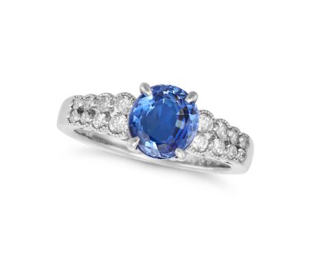 A SAPPHIRE AND DIAMOND RING in platinum, set with an oval cut sapphire of 2.04 carats on a bifurcated band set with round bri