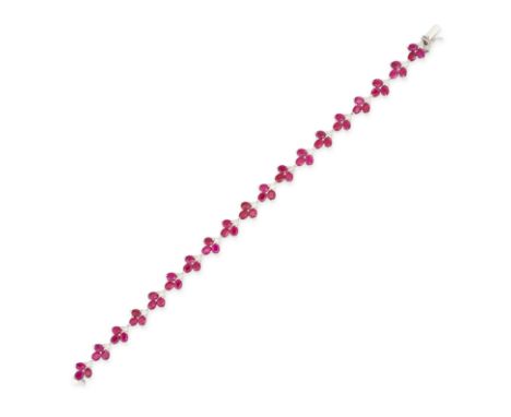 A RUBY AND DIAMOND BRACELET in 18ct white gold, set with nineteen clusters of oval cut rubies accented by round brilliant cut