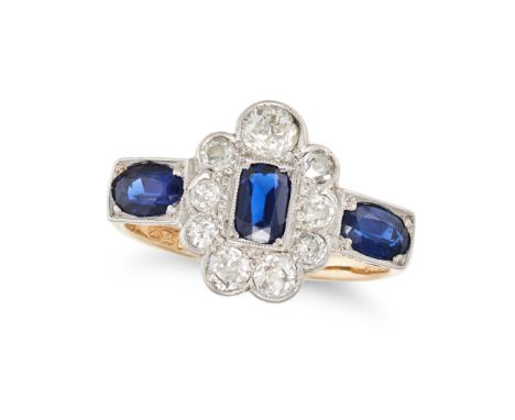 A VINTAGE, A SAPPHIRE AND DIAMOND RING in 18ct yellow gold and platinum, set with a cushion cut sapphire in a cluster of old 