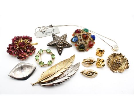 A group of mainly branded cotsume jewellery, including a multi coloured paste set Sphinx brooch, a Monet pendant still with o