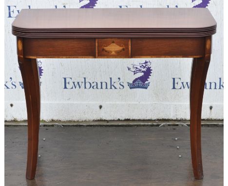 A Regency style mahogany card table, of D-shaped form, the foldover top revealing a tooled green leather inset, on reeded squ