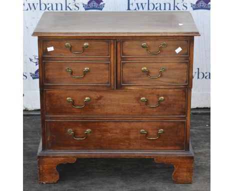 A George III style mahogany drinks cabinet, adapted with George III elements, the hinged top above two cupboard doors modelle