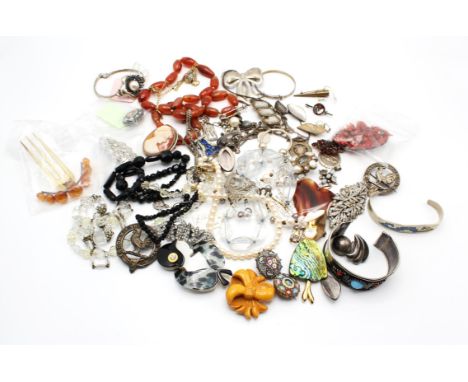 A group of costume jewellery including an antique tortoiseshell and copal resin hair piece, a Monet rock crystal necklaces wi