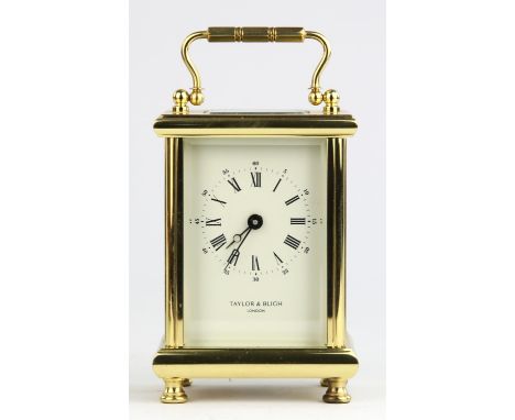 A modern brass cased carriage clock, with visible escapement over a white enamelled dial plate, detailed 'TAYLOR & BLIGH LOND