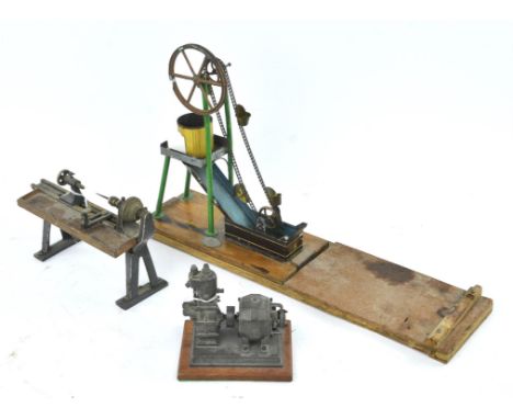 An early 20th century tin plate water pump in the form of a chain driven well, with Gamages plaque to base, 27cm high, a mini