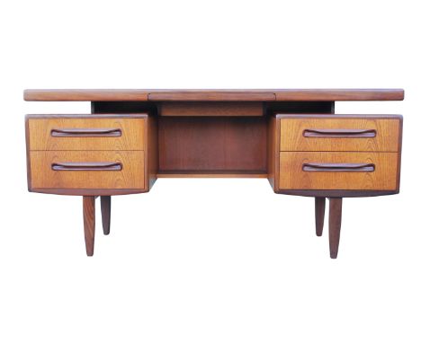 G PLAN, a teak dressing table, with central frieze drawer above a shelf, flanked by two sets of drawers, on turned legs, 71cm