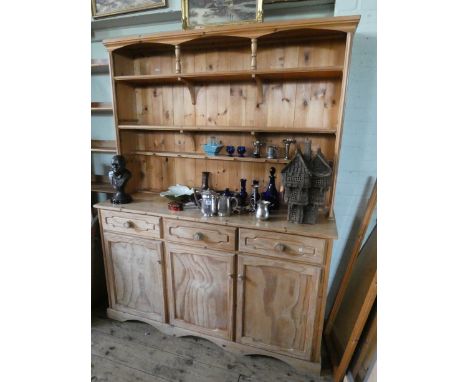 A stripped pine kitchen dresser with shelf back, drawers and cupboards under 5' wide 