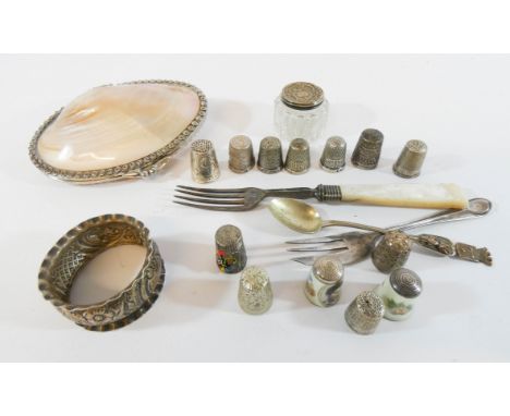 A small collection of silver an plated items to include seven silver thimbles, silver napkin rings and dressing table jar tog