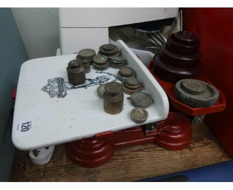 A set of balance scales with a large quantity of assorted weights 