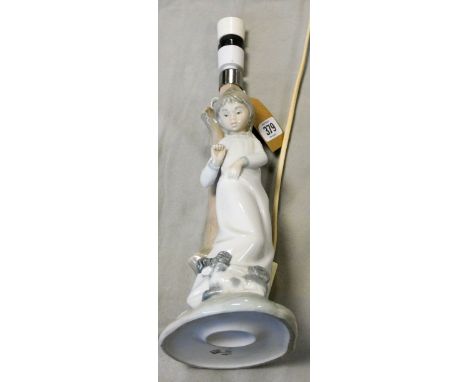 A Nao lamp with a young person leaning against a tree trunk 