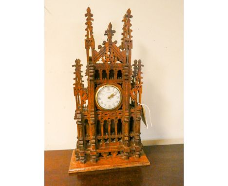 A small Cathedral clock in carved oak case, 14" high X 18" wide 