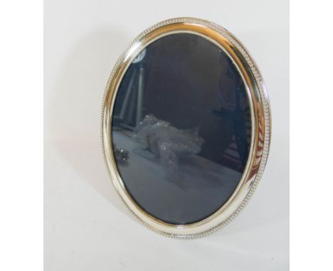 An oval silver hallmarked photograph frame with easel fitting, approximately 22cm tall  