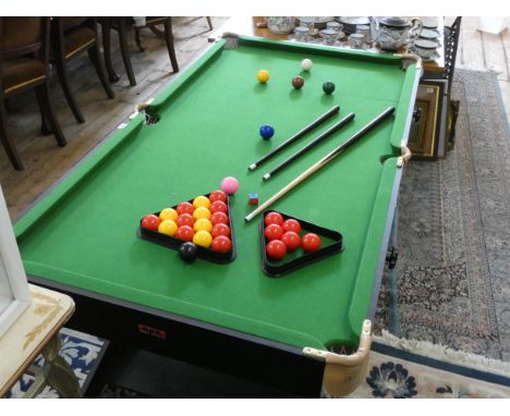 A smaller snooker table complete with balls, cues etc 