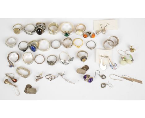 Nineteen silver rings including tiger's eye, locket, shell, lapis lazuli, one Links of London, etc, twelve pairs of silver ea