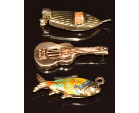 Three 9ct gold charms one in the form of a boat, one a guitar and the other a fish set with enamel, 4.1g