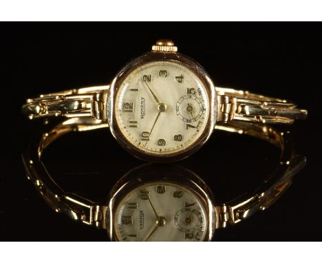 Rotary 9ct gold ladies wristwatch with subsidiary seconds dial, gold hands and Arabic numerals, silver dial and calibre 810 m