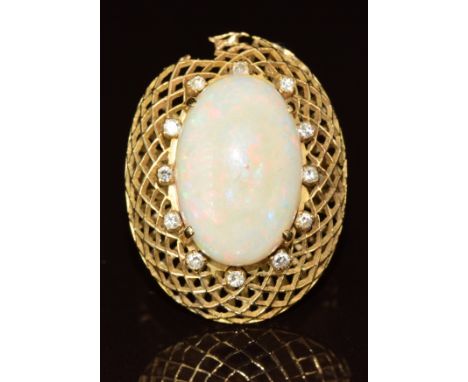 An 18k gold ring set with an opal cabochon surrounded by diamonds, in a lattice setting (setting damaged), 8.9g, size L