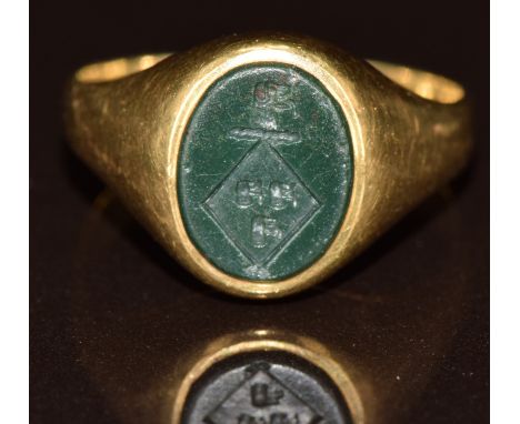 A yellow metal signet ring set with a hardstone intaglio seal, 4.4g, size G/H