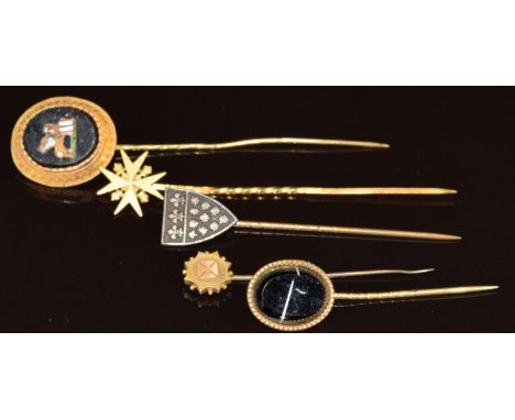 A 19thC yellow metal stick pin set with a micro mosaic depicting a lion with wings holding a flag, two yellow metal stick pin