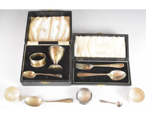 Cased hallmarked silver christening set, cased hallmarked silver spoon and fork set, three hallmarked silver napkin rings and