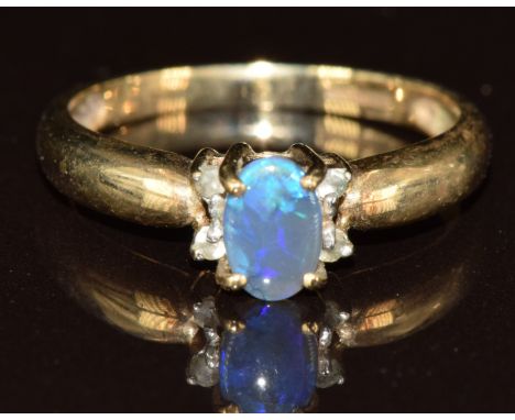A 9ct gold ring set with an Andamooka semi black opal and topaz, size K, 1.9g