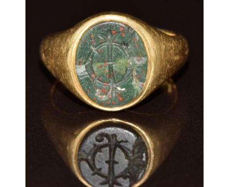 An 18ct gold signet ring set with a bloodstone intaglio seal, London 1919, 9.1g, size N