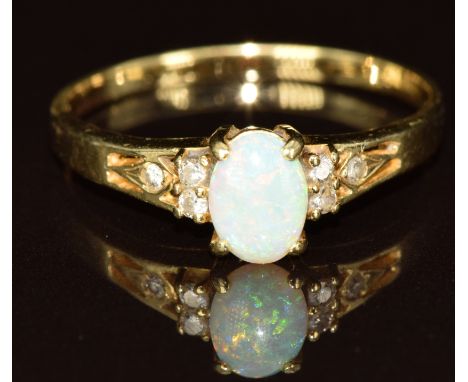 A 14k gold ring set with an opal cabochon and diamonds, 2.3g, size S