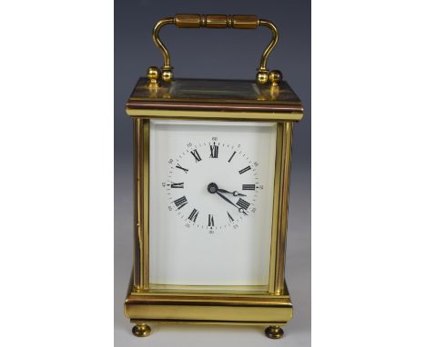 Brass carriage clock with bevelled glass panels, marked to the movement made in England, H12cm