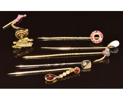 Five 9ct gold stick pins, one set with seed pearls and garnets, one with diamond, one synthetic rubies, one opal and one sapp