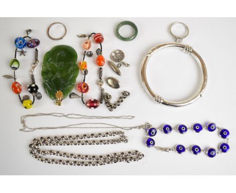 A collection of jewellery including carved jadeite pendant with yellow metal loop, jadeite ring, silver bangle, two silver ri