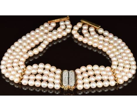 A four strand cultured pearl necklace with 18k gold pendant set with round cut diamonds, two 18k gold spacers set with three 