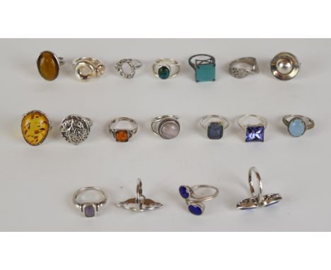Eighteen silver rings including pressed amber, tiger's eye, amethyst, agate, etc&nbsp;