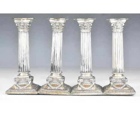 Set of four Dutch silver Corinthian column silver candlesticks having ram's head decoration to the corners of the bases, with