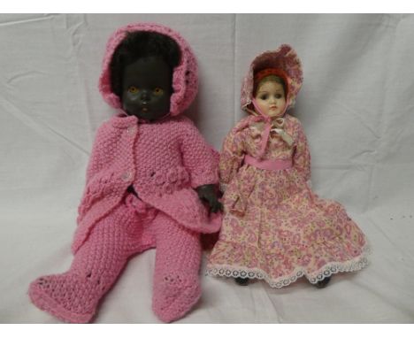 A child's old doll with ceramic head and limbs and an English rubber bodied doll (2)