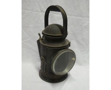 An old brass mounted painted metal Railway hand lamp with internal burner and reflector, the case marked "1901"