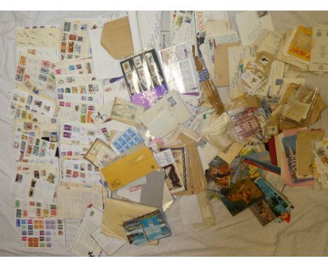 A box containing a large selection of World stamps in packets, first day covers, presentation packs, numerous club books of s