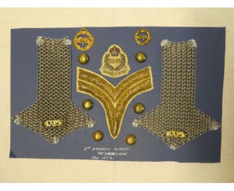 A display of the 2nd The Queen's Bays Dragoon Guards insignia including embroidered wire badge, chevron, chain mail epaulette