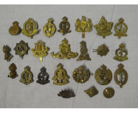 Various original military cap badges including Royal Canadian Army Medical Corps, Military Police, Army Educational Corps, RA