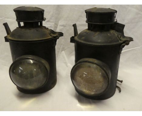 A pair of painted metal Railway bracket lamps with bulls-eye glass lenses and original internal lamp fitments