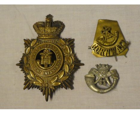 A brass ordinary ranks helmet plate of the Duke of Cornwall's Light Infantry with detachable centre, shoulder title and pin-b