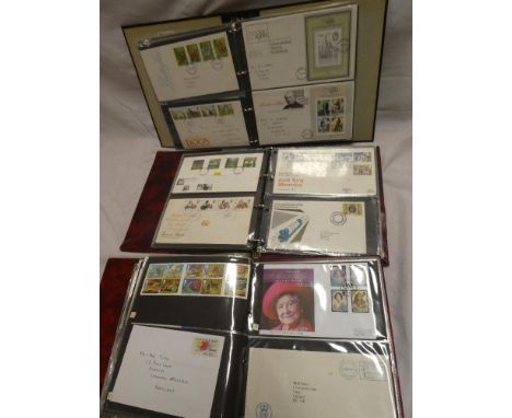 Three albums containing a selection of GB first day covers 1970's-1990's together with stamp presentation packs etc