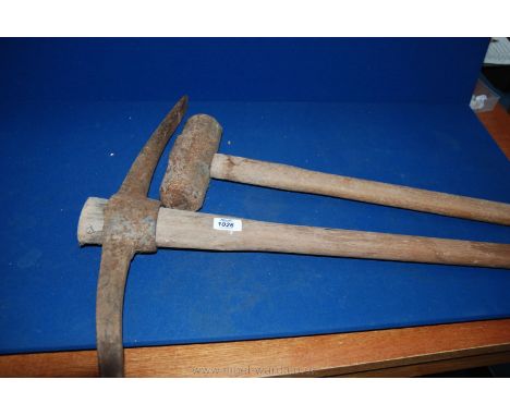 A long handled Pick axe and a sledge Hammer