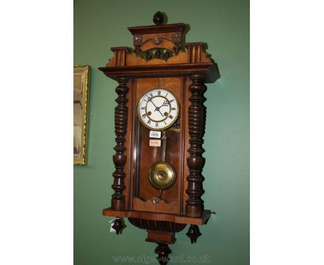 A 19th century walnut cased Vienna Wall Clock having finial pediment top with spindle turned detail, half turned columns flan