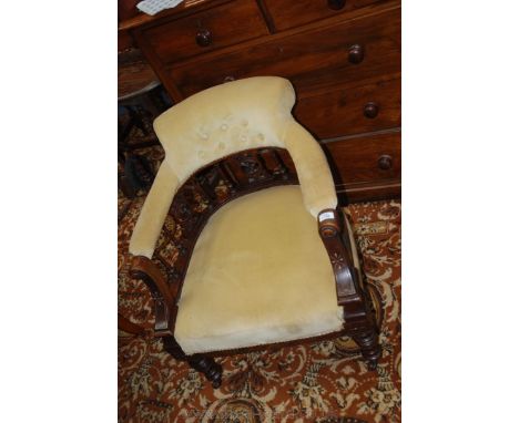 A Victorian Walnut show framed Salon tub Chair having pastel yellow velvet button back pad and seat, the back on turned spind