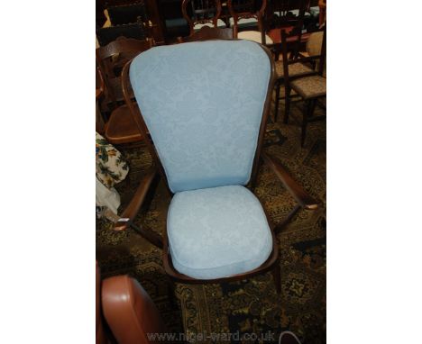 An Ercol stick-back Grandfather style Chair, stick back with curved arms and on turned legs and stretchers.