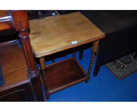 A 1940's light Oak occasional Table, with wavy edged rectangular top, on barley twist legs with lipped lower tier