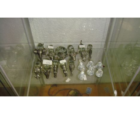 Shelf of pewter animal serviette rings and Swarovski style animal ornaments