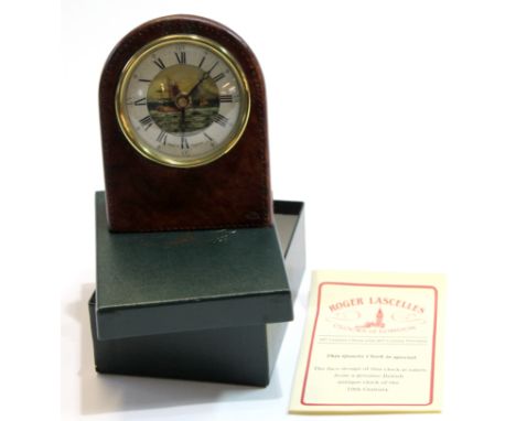 Small table clock with picturesque dial in leather frame with certificate "Made by Roger Lascelles", 13cm high  