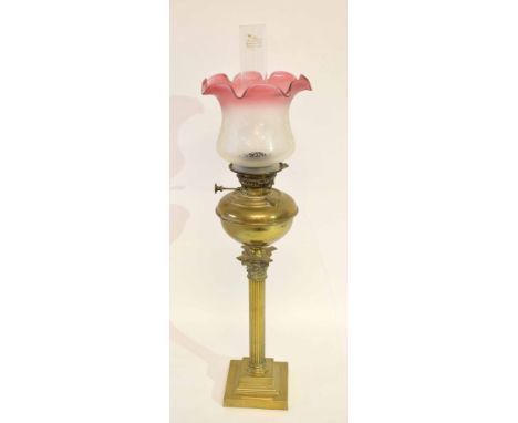 German Veritas brass Corinthian column oil lamp with glass shade with floral decoration and cranberry coloured rim, the brass